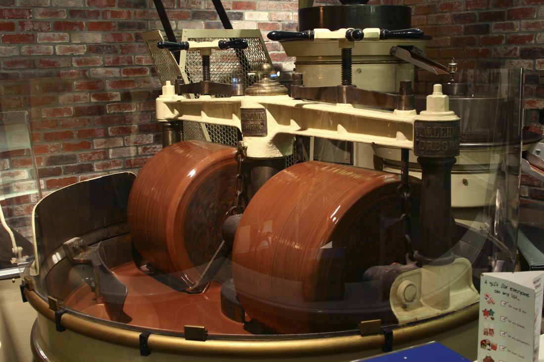 A stone melanger grinding liquid chocolate