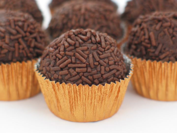 Round brigadeiros covered in chocolate sprinkles in paper cases