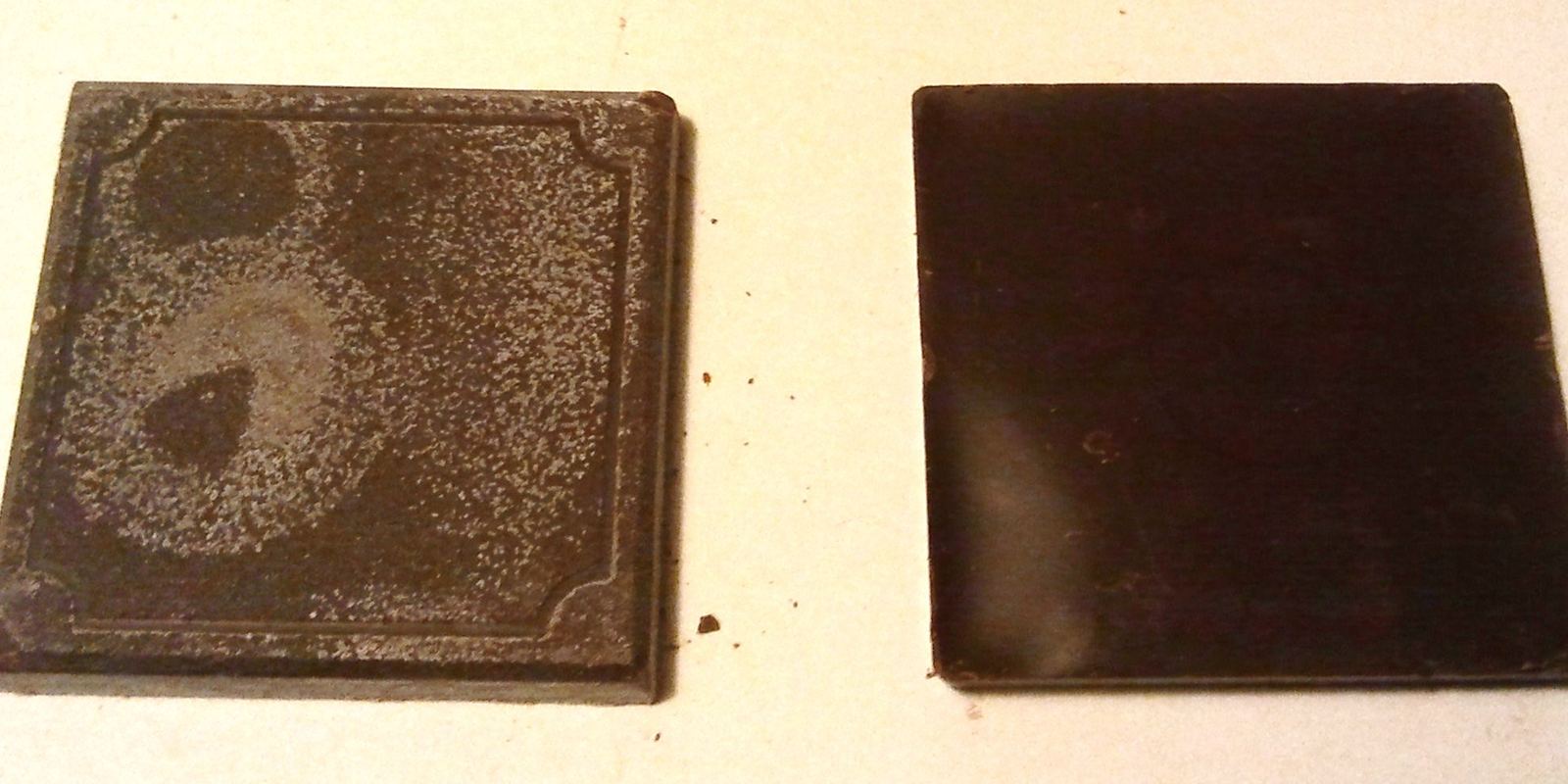 A chocolate bar with streaky grey-white fat bloom on its surface