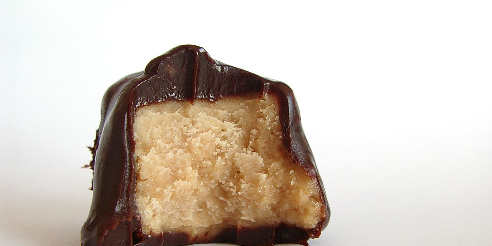 A cake covered with a glossy chocolate ganache