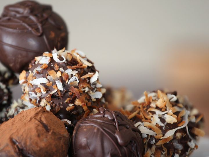 Round chocolate truffles dusted with cocoa and chopped nuts