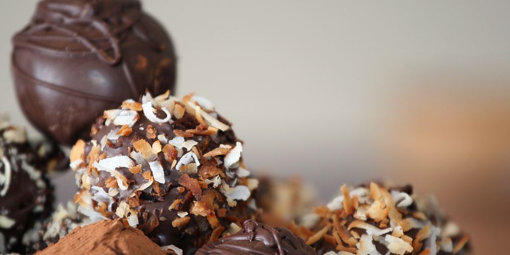 Round chocolate truffles dusted with cocoa and chopped nuts