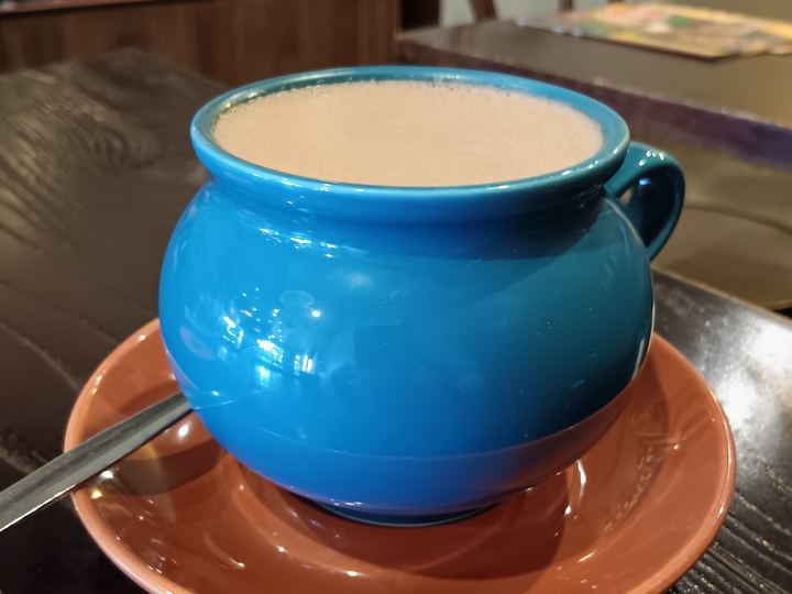 A cup of dark hot chocolate viewed from above