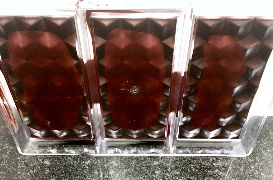 Glossy tempered chocolate bars in a clear mould